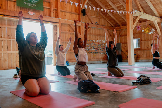 Women enjoying a wellness yoga session at Camp Social