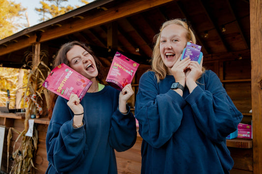 Two women smiling and bonding as new friends by Camp Social