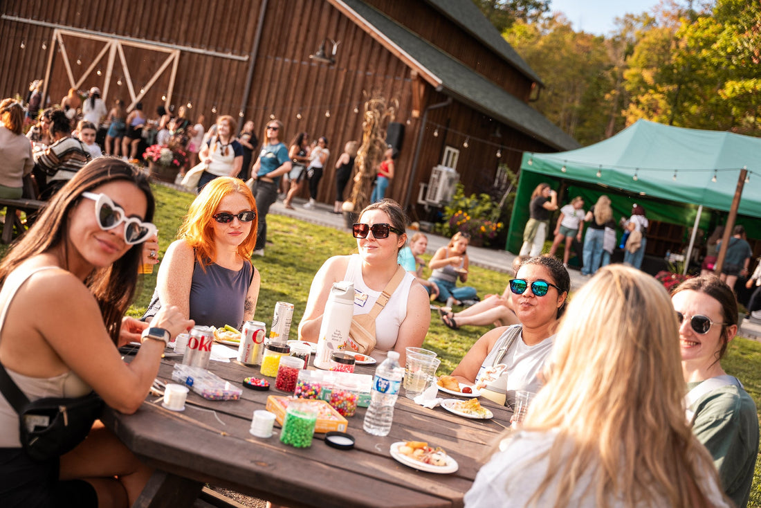Women enjoying a relaxed outdoor gathering at a women’s summer camp