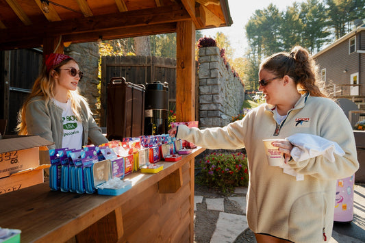 Woman buying snacks at an outdoor camp booth