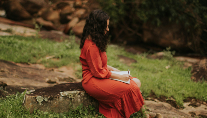 Woman journaling alone outdoors